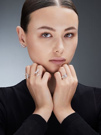 model wears lab grown diamond necklaces and earrings by Swarovski