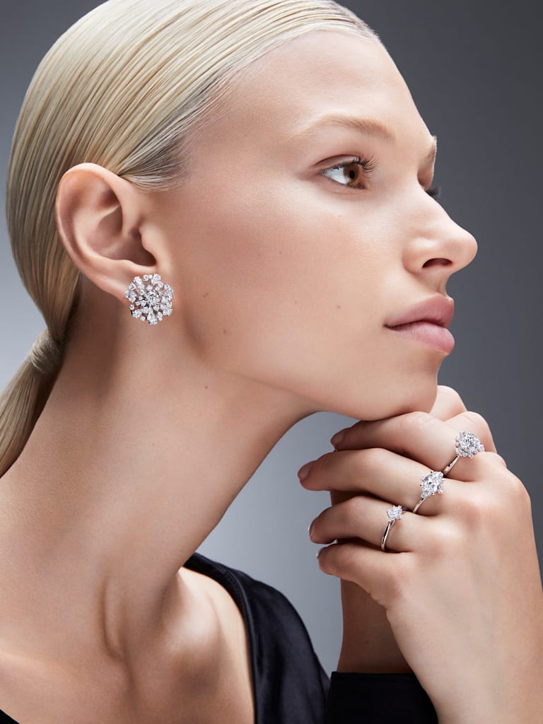 model wears lab grown diamond rings and earrings by Swarovski