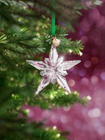 Swarovski crystal star ornament with pink backround.