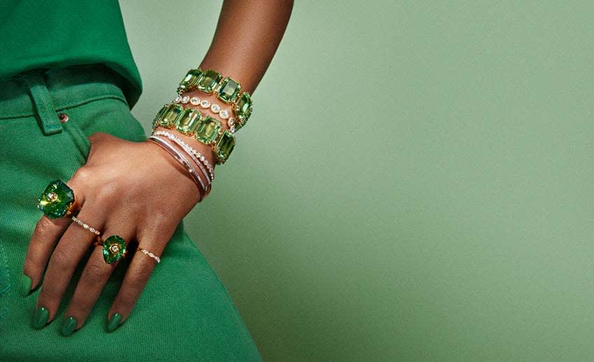 Model wearing stacked Swarovski bracelets