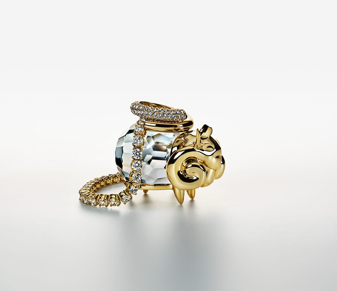 Aries Zodiac figurine draped with jewelry
