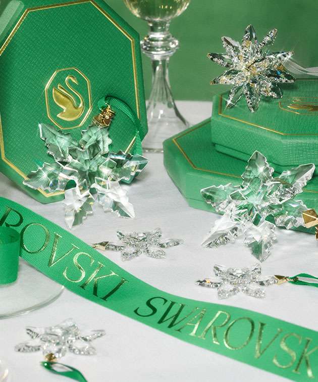 Annual Edition Ornaments on table with green ribbon