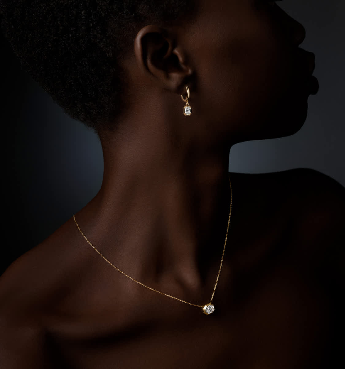 Model wearing Swarovski Octagon earrings and pendant