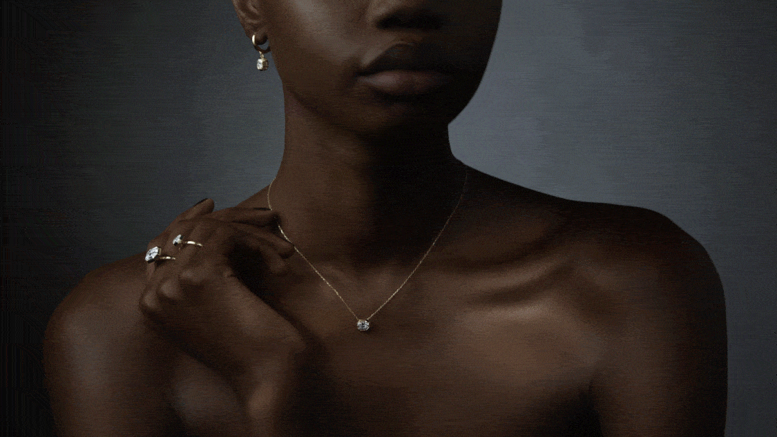 Model wearing Swarovski Octagon earrings, pendant and rings