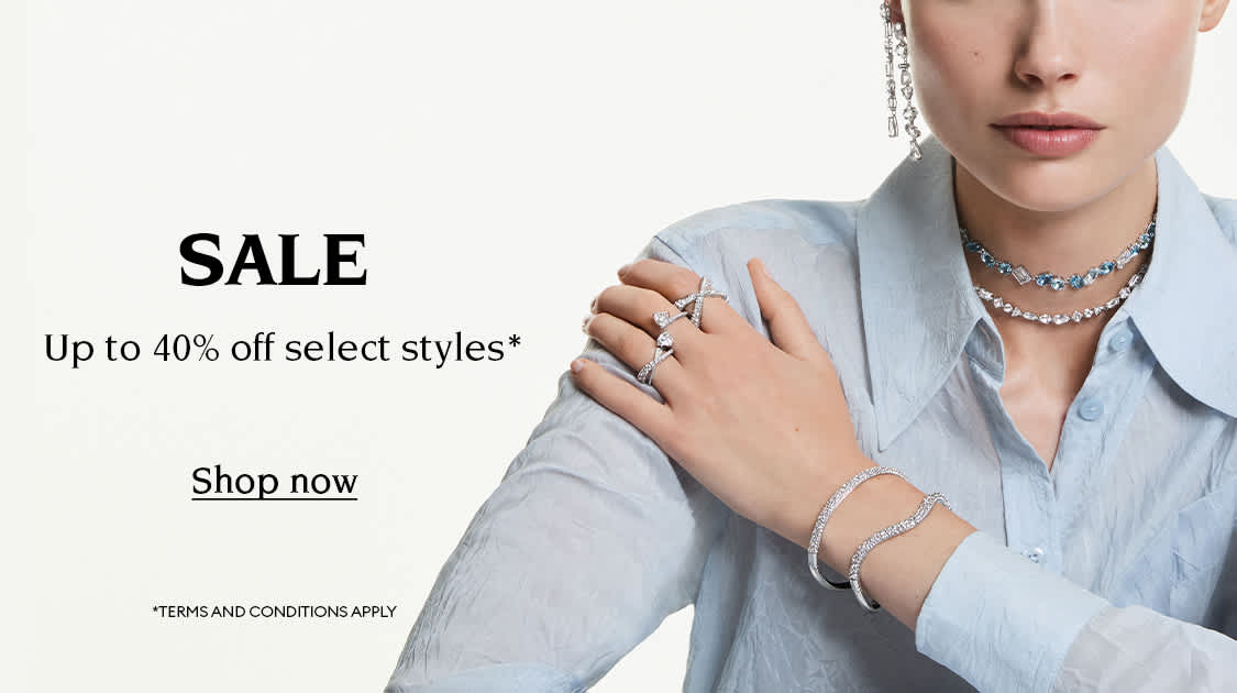 Model wearing Swarovski jewellery. Text reads 