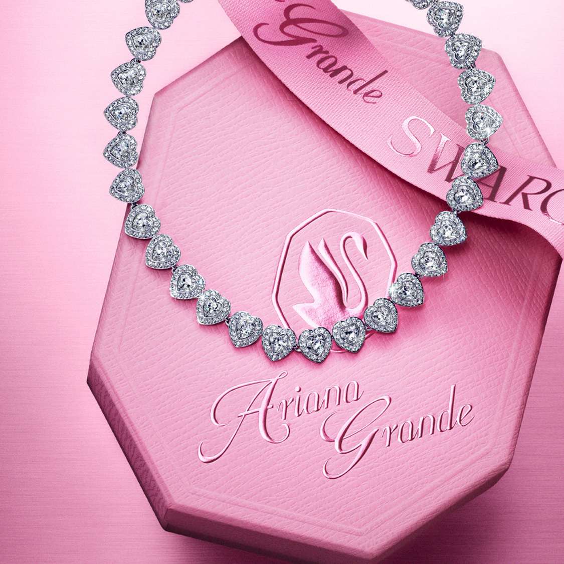 Ariana Grande x Swarovski necklace on top of pink Swarovski box