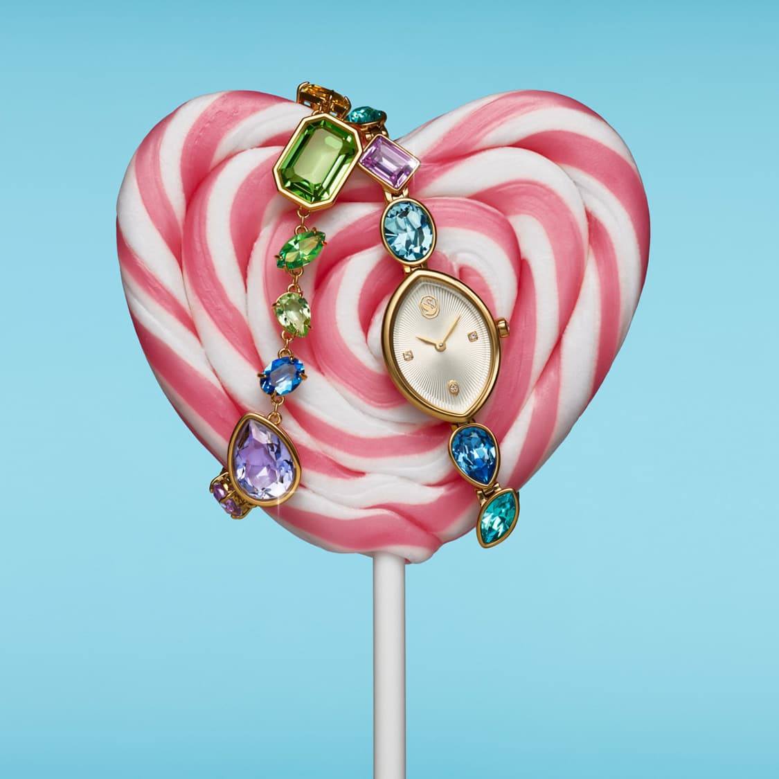 Gema bracelet and watch displayed on a heart-shaped lollipop
