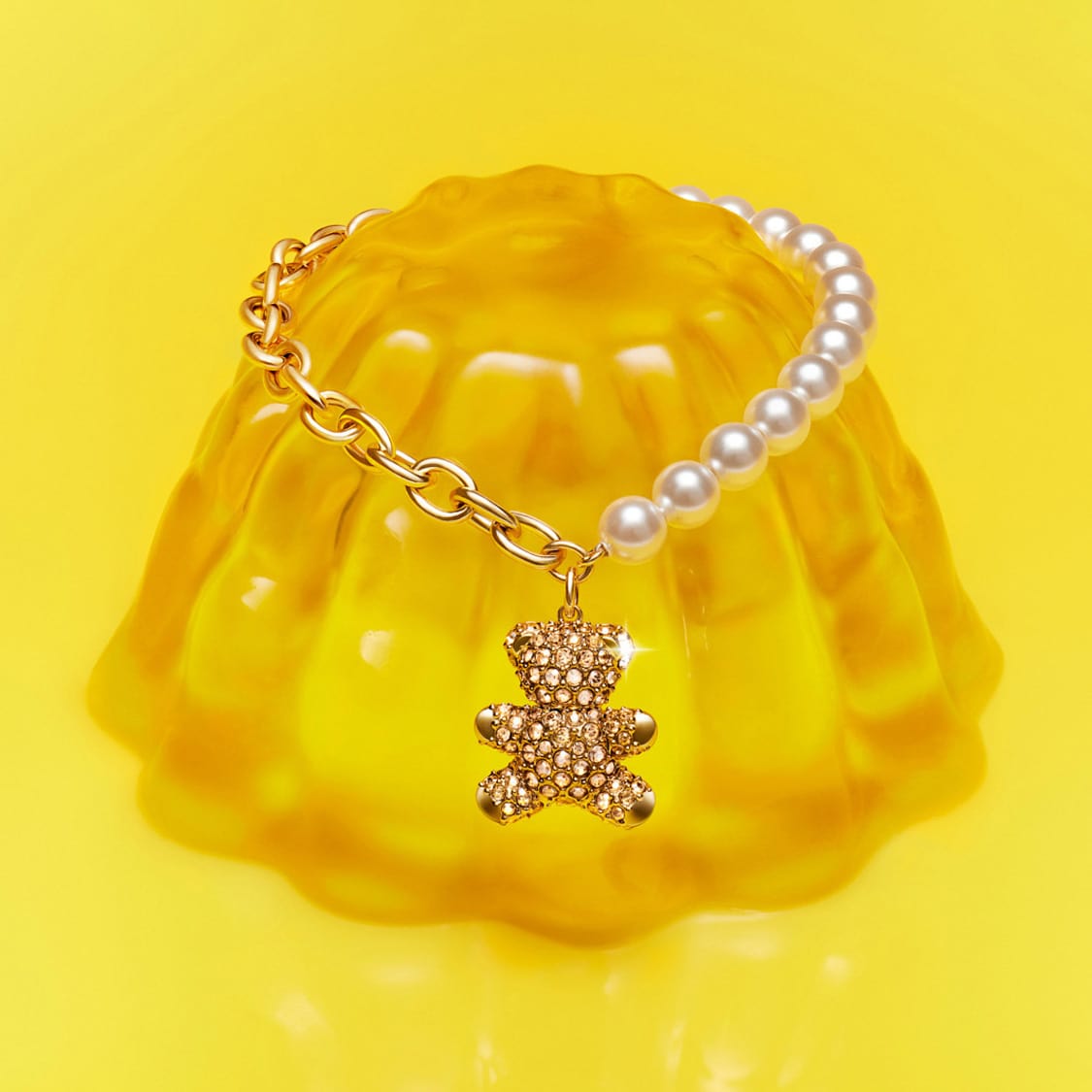 Swarovski charm carrier bracelet and Teddy Bear charm on yellow jelly