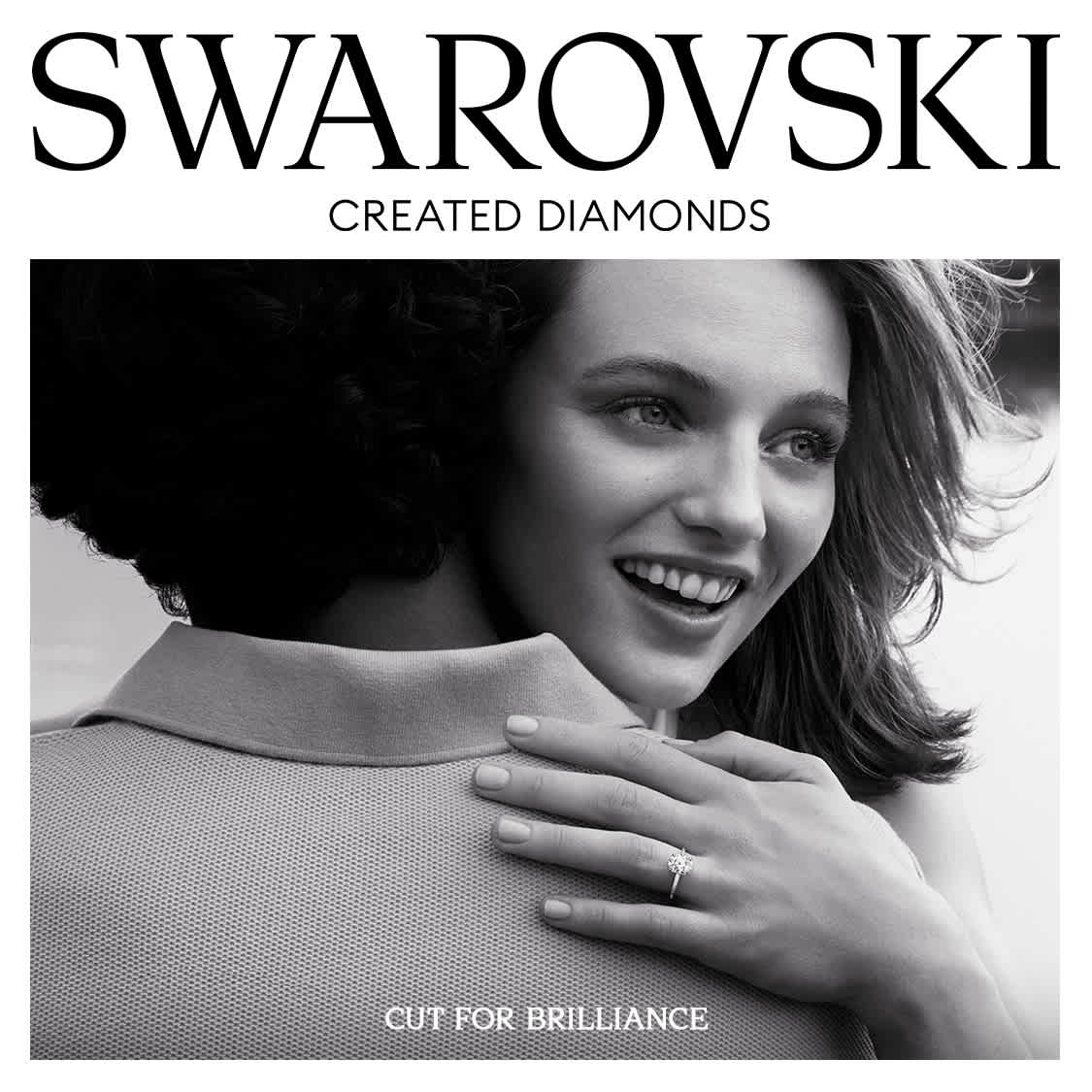Models hugging, with a diamond ring visible.