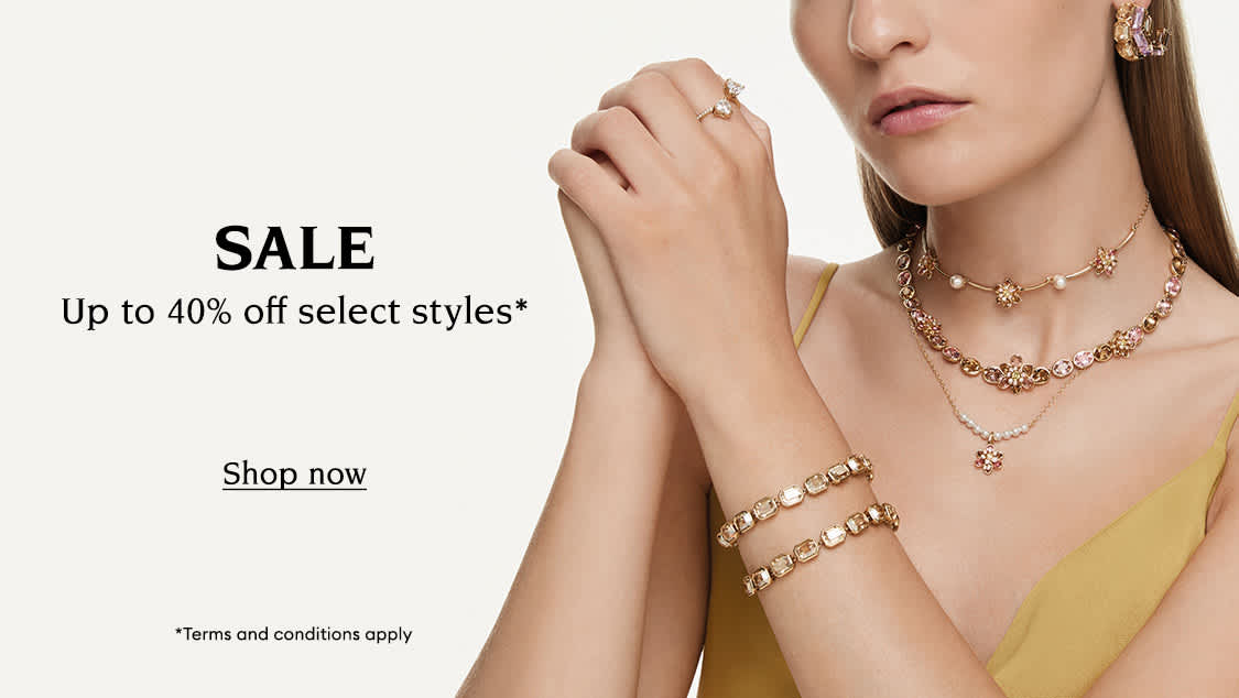 Model wearing Swarovski jewellery. Text reads 
