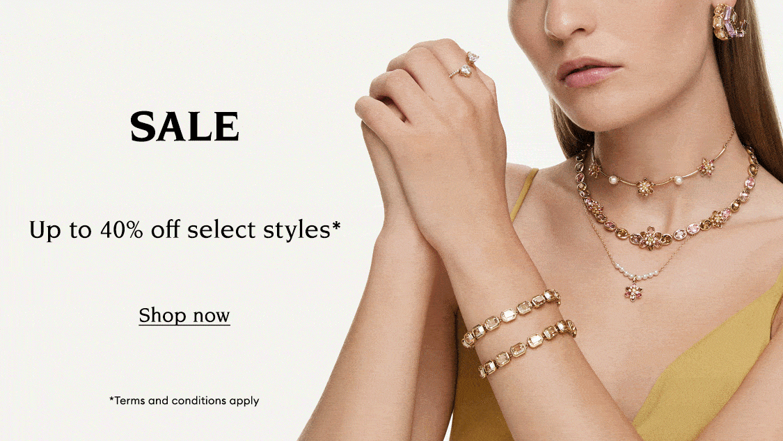 Model wearing Swarovski jewellery. Text reads 