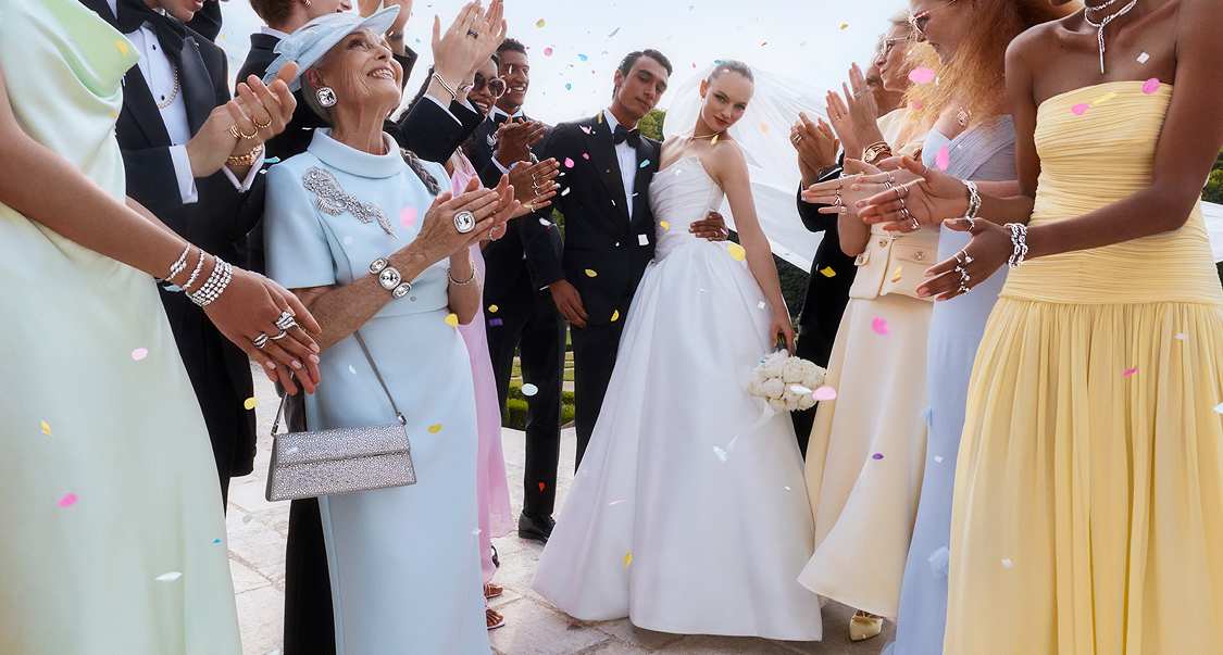Bride and groom with guests applauding